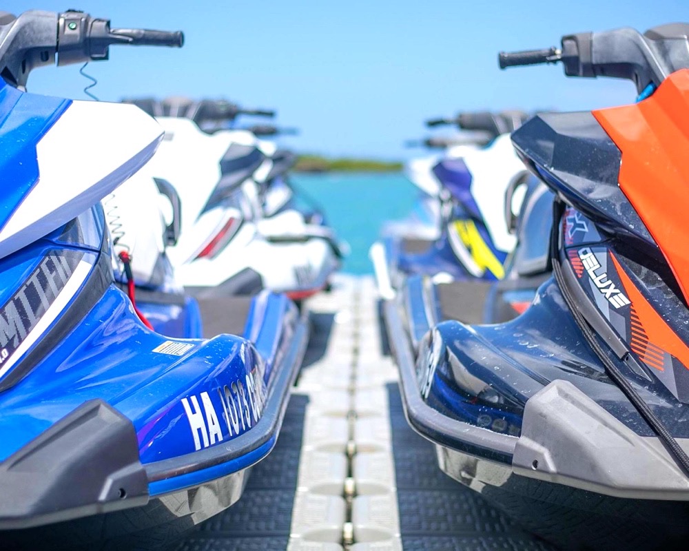 Yamaha and Sea-Doo jet skis lined up on dock