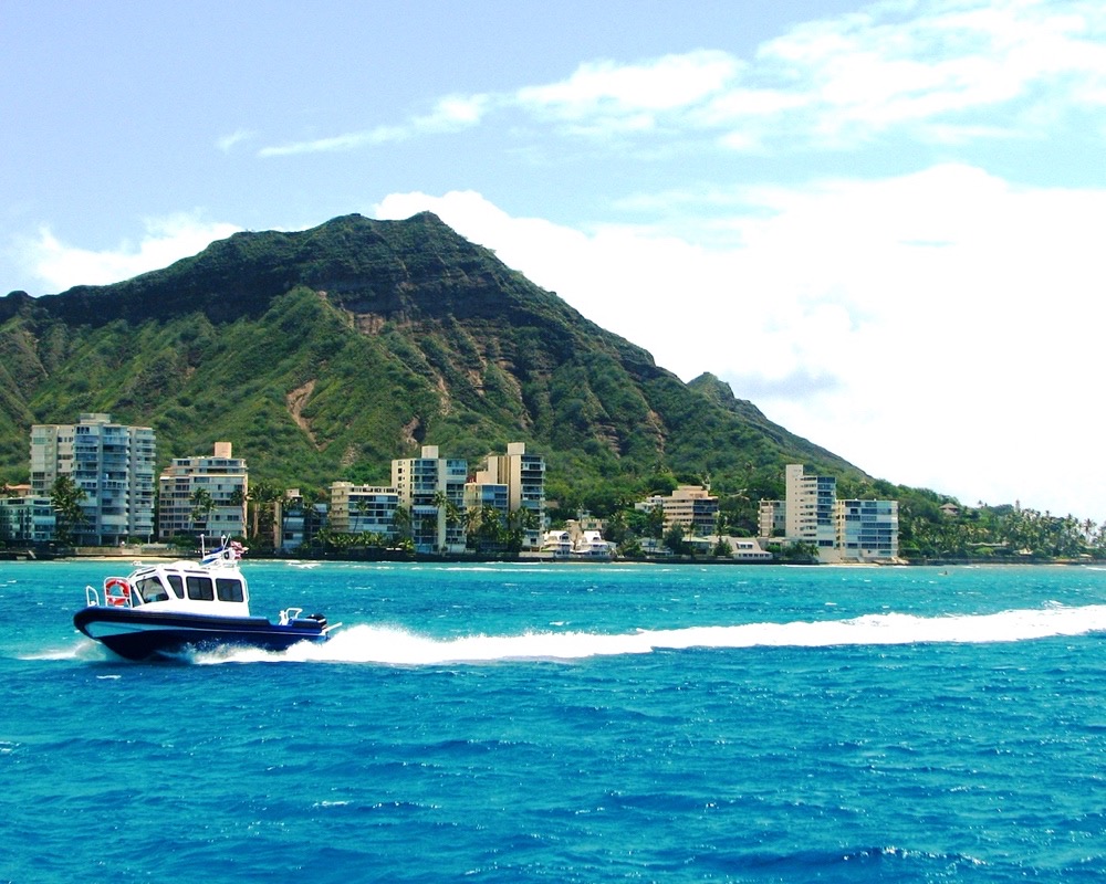 Boat cruising past Diamond Head, Oahu